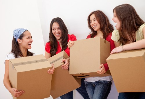 Removal team handling student belongings in a central London flat