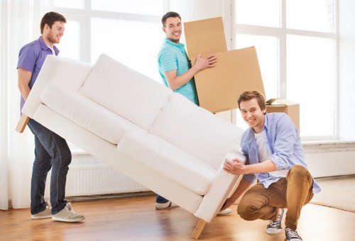 Movers planning a safe route through a property with furniture