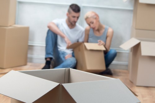 Staff wearing PPE while loading boxes and furniture