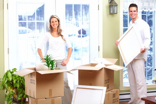 Professional movers handling office furniture in central London